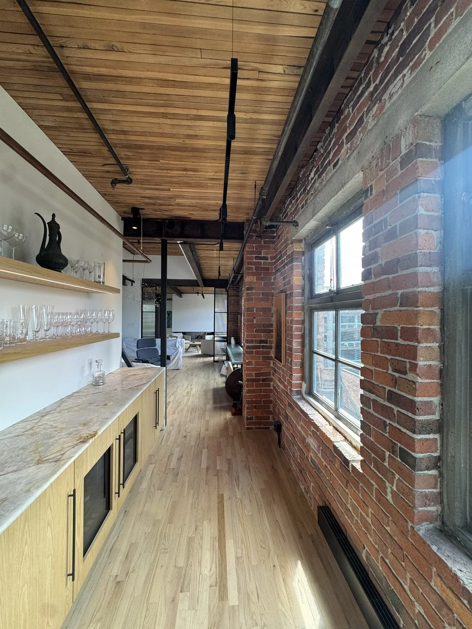 Exposed brick wall, floating shelves and black steel window in the Powell loft renovation, Vancouver BC