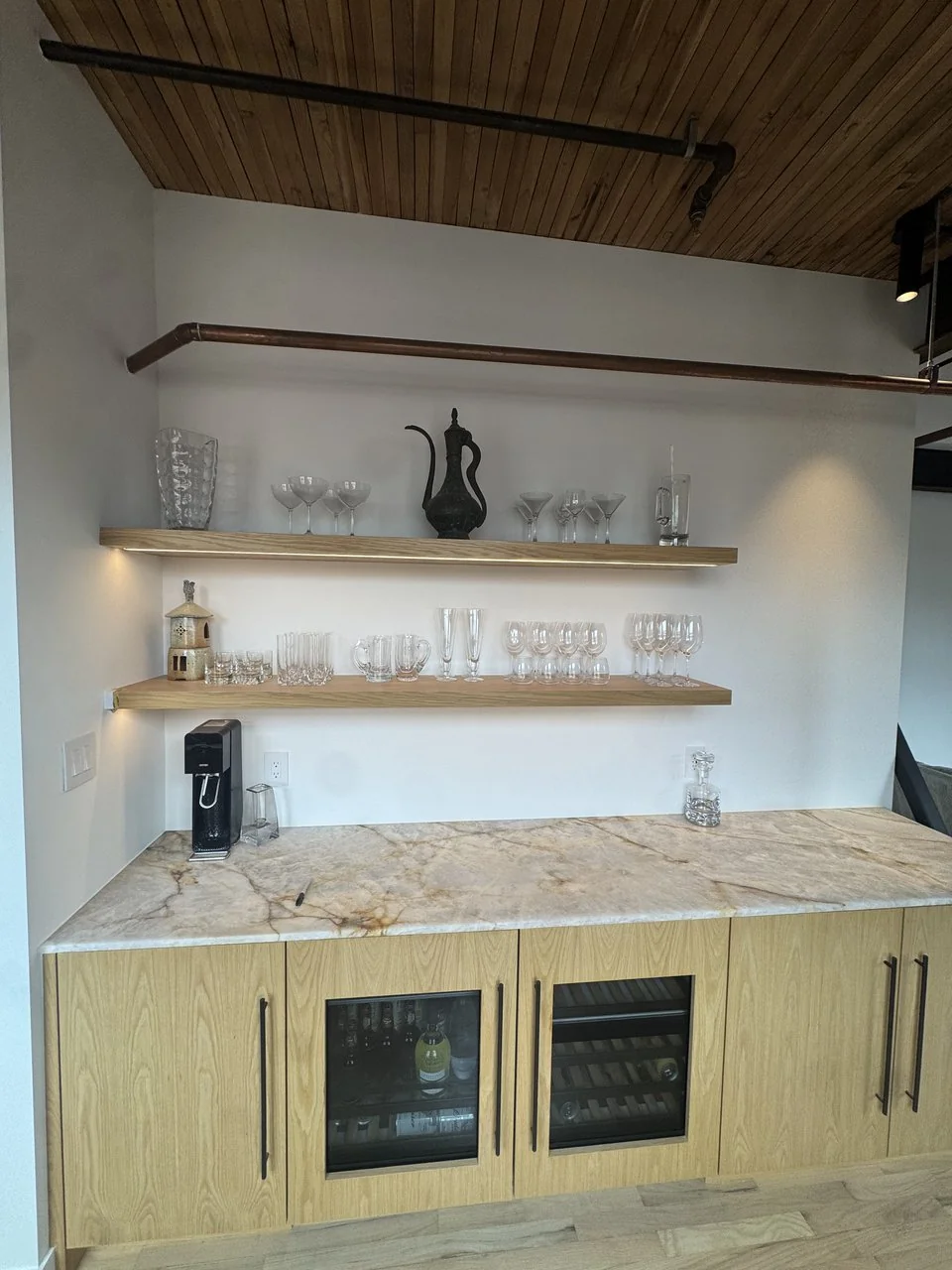 Floating oak shelves over a stone bar counter, Powell loft renovation, Vancouver BC