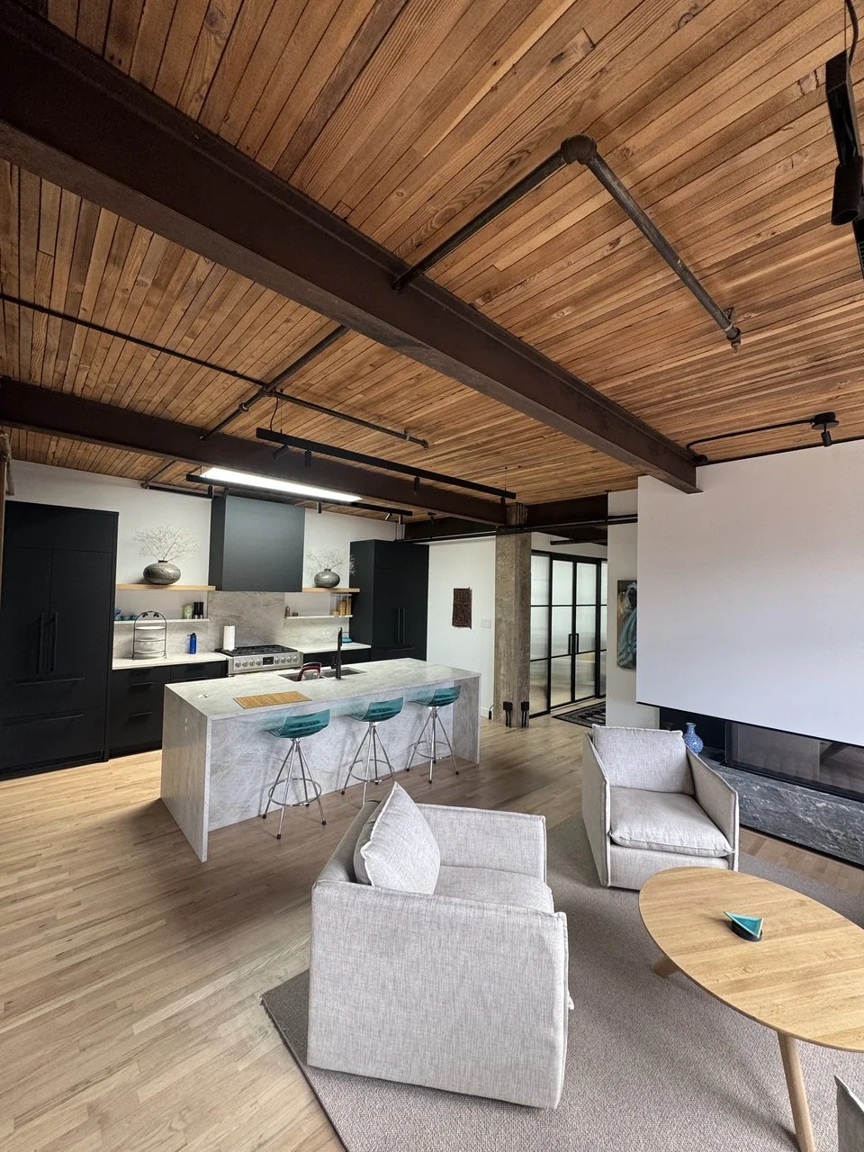 Open plan loft kitchen and living area from the Powell design-build renovation by Mulder Contracting, Vancouver BC